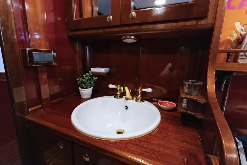Slide: The Image of Elegant wooden vanity with brass fixtures on 1929 Lyman-Morse Staysail Schooner. - 49