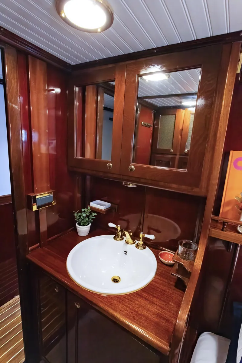 Slide: The Image of Elegant wooden vanity in 1929 Lyman-Morse Staysail Schooner bathroom. - 50