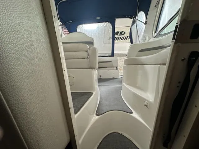 Slide: The Image of Interior view of 2006 Chaparral 290 Signature boat, featuring seating and blue canopy. - 3