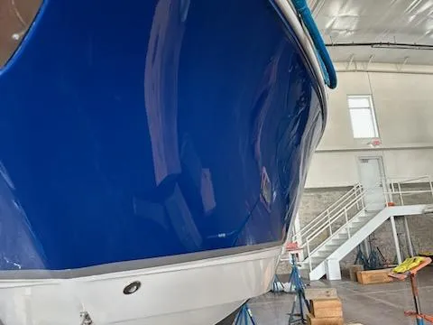 Slide: The Image of 2006 Chaparral 290 Signature boat in indoor storage, blue hull, side view. - 4