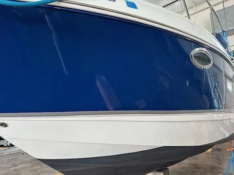 Slide: The Image of 2006 Chaparral 290 Signature boat with blue and white hull in a storage facility. - 6