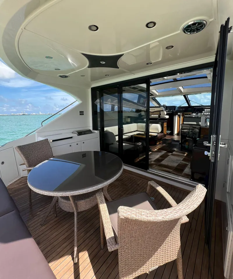 Slide: The Image of 2011 Marquis 500 Sport Coupe yacht with outdoor seating and ocean view. - 10