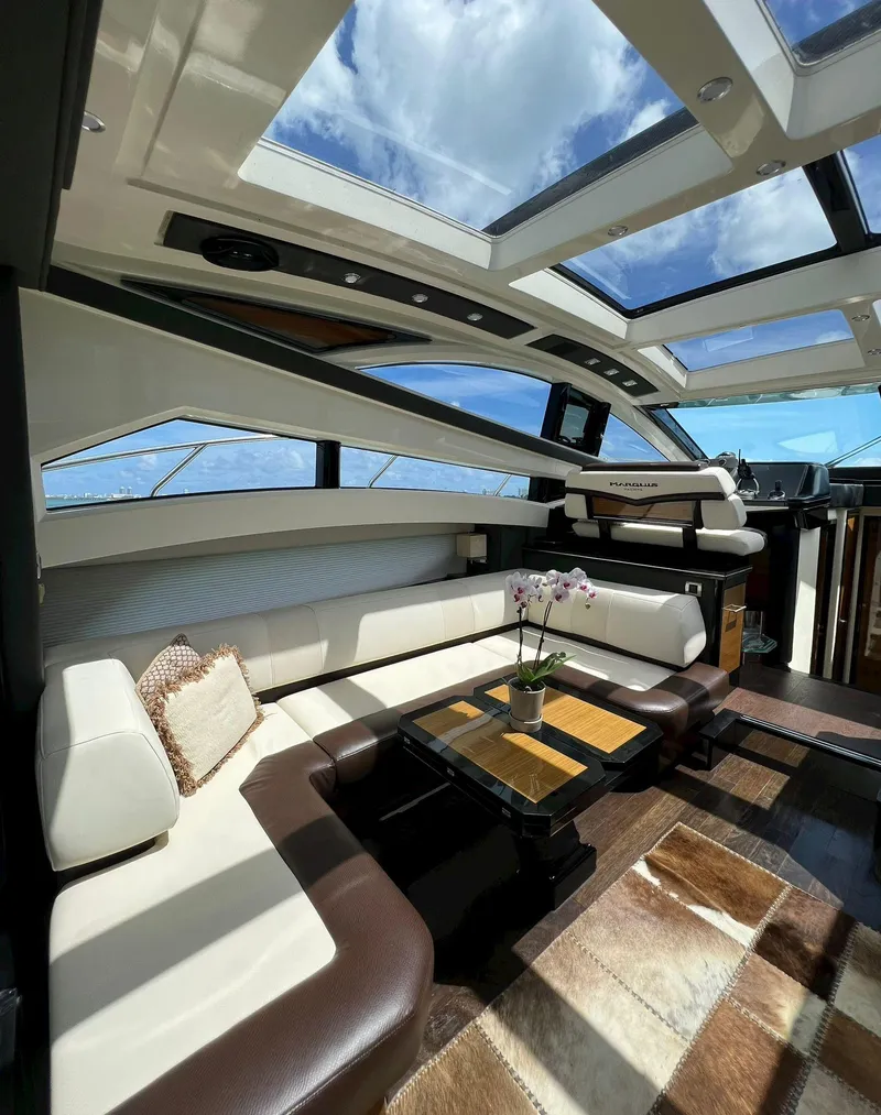 Slide: The Image of Luxurious interior of a 2011 Marquis 500 Sport Coupe yacht with panoramic windows and plush seating. - 11