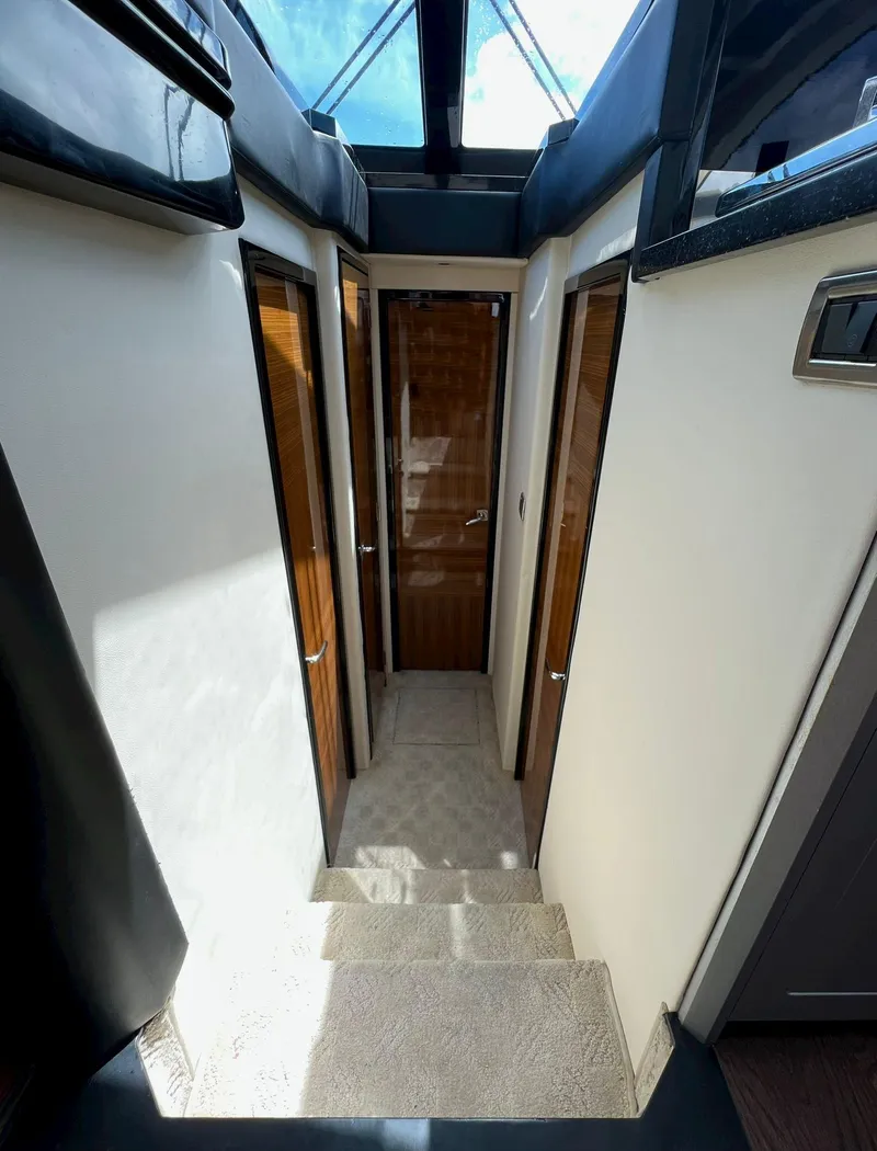 Slide: The Image of Interior hallway of a 2011 Marquis 500 Sport Coupe yacht with wooden doors. - 16