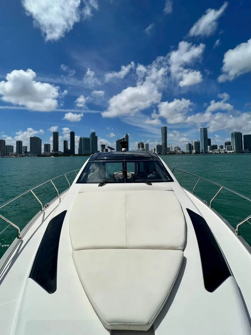 Slide: The Image of 2011 Marquis 500 Sport Coupe yacht cruising with city skyline backdrop. - 7