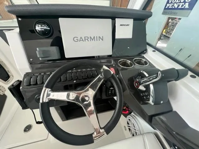Slide: The Image of 2024 Blackfin 252 DC boat helm with Garmin navigation and Mercury controls. - 12