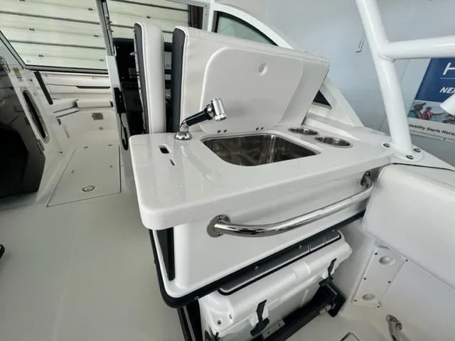 Slide: The Image of 2024 Blackfin 252 DC boat interior with sink and storage compartments. - 13
