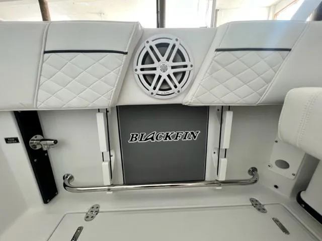 Slide: The Image of 2024 Blackfin 252 DC boat interior with speaker and logo. - 14