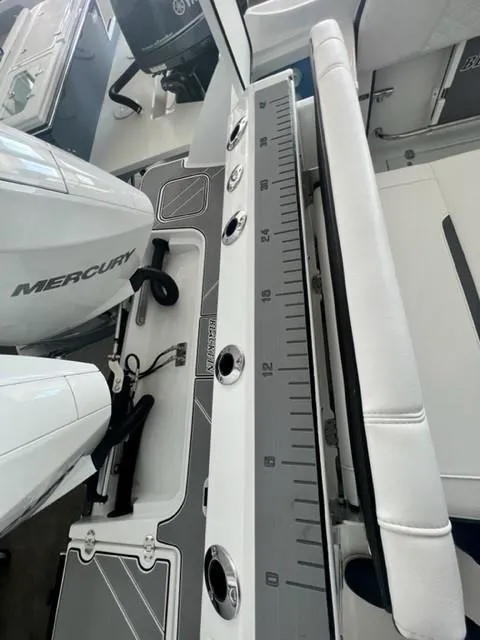 Slide: The Image of 2024 Blackfin 252 DC boat interior with Mercury engine and measuring scale. - 15
