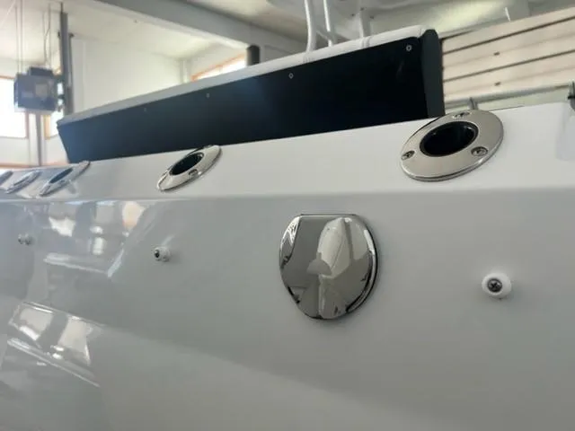 Slide: The Image of Close-up of 2024 Blackfin 252 DC boat's sleek white exterior. - 17