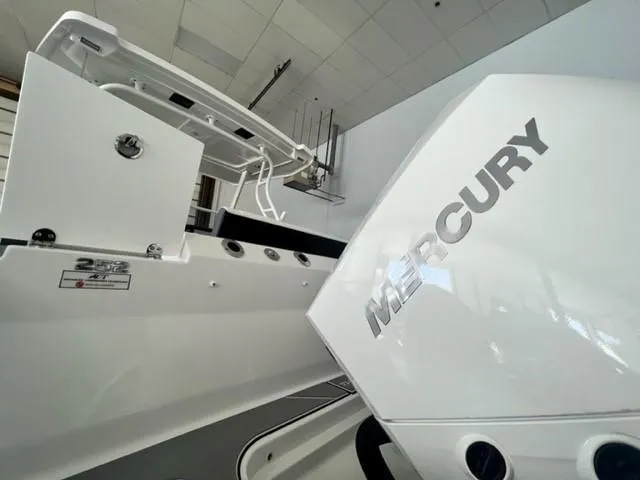 Slide: The Image of 2024 Blackfin 252 DC boat with Mercury engine in showroom. - 19