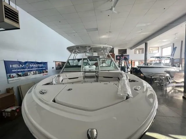 Slide: The Image of 2024 Blackfin 252 DC boat displayed in a showroom. - 20