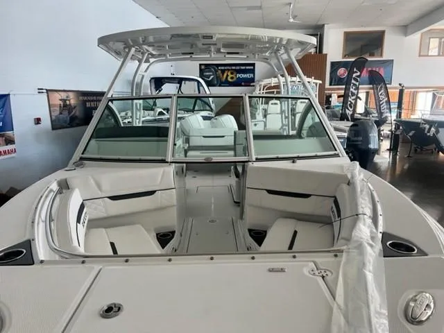 Slide: The Image of 2024 Blackfin 252 DC boat interior with seating and windshield in showroom. - 21