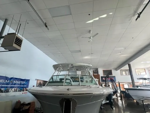 Slide: The Image of 2024 Blackfin 252 DC boat displayed in an indoor showroom. - 22