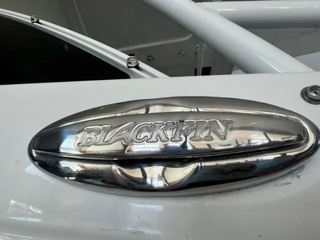 Slide: The Image of 2024 Blackfin 252 DC boat logo on a metallic surface. - 23