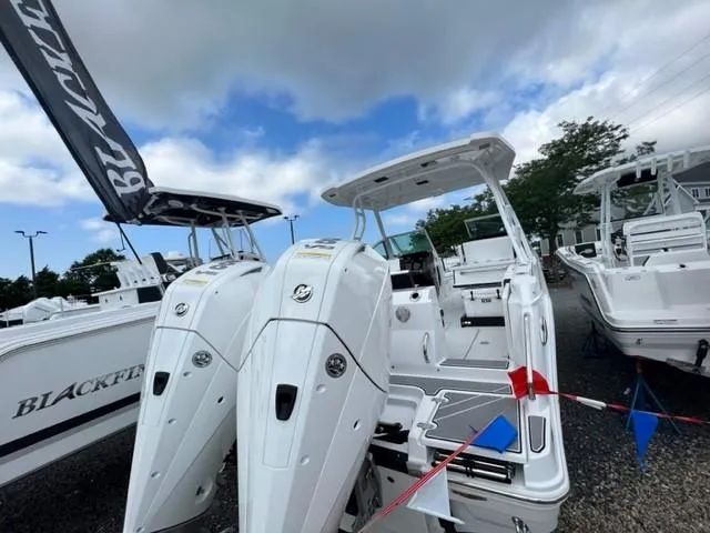 Slide: The Image of 2024 Blackfin 252 DC boat with twin engines on display. - 3