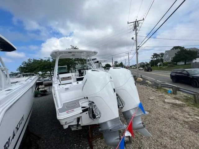 Slide: The Image of 2024 Blackfin 252 DC boat with dual outboard engines on display. - 4