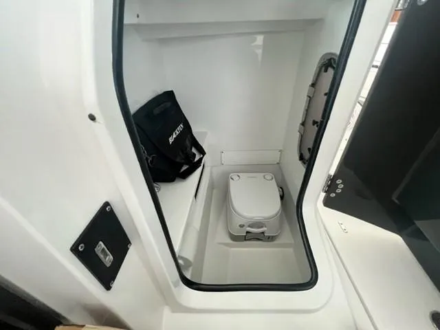 Slide: The Image of 2024 Blackfin 252 DC boat interior with compact marine toilet. - 9