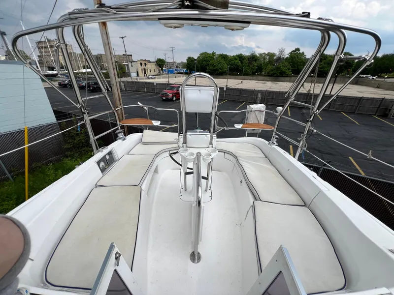 Slide: The Image of 2005 Hunter 36 sailboat cockpit with cushioned seating and steering wheel. - 22
