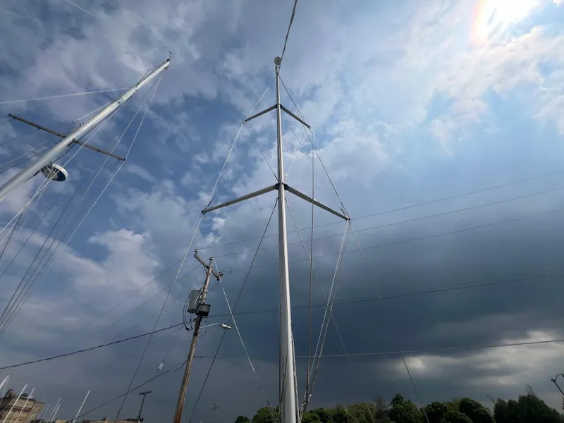 Slide: The Image of Mast of 2005 Hunter 36 sailboat against a cloudy sky. - 25