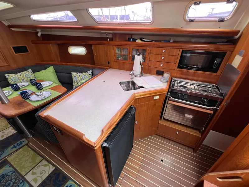 Slide: The Image of Interior of a 2005 Hunter 36 sailboat with kitchen and dining area. - 28