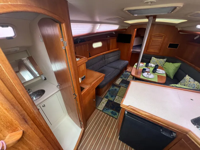 Slide: The Image of Interior of 2005 Hunter 36 sailboat with cozy seating and kitchenette. - 29