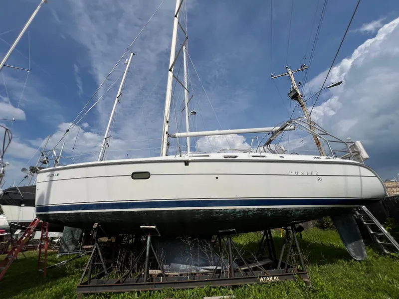 Slide: The Image of 2005 Hunter 36 sailboat on a stand, blue sky background. - 3