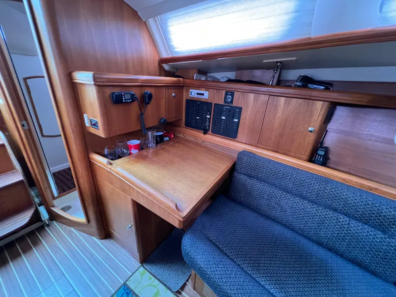Slide: The Image of Interior of a 2005 Hunter 36 sailboat with navigation station and seating area. - 33