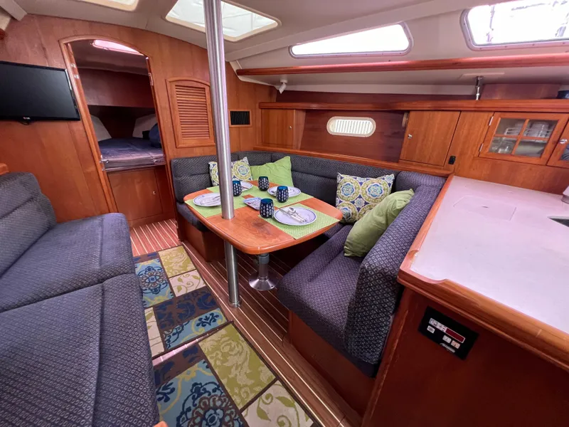 Slide: The Image of Interior of a 2005 Hunter 36 sailboat with cozy seating and dining area. - 38