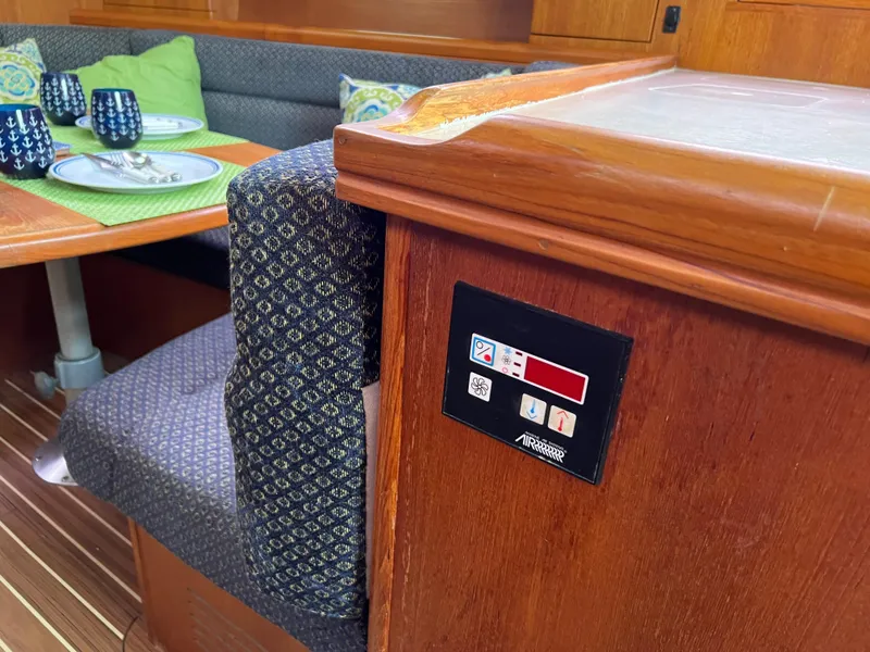 Slide: The Image of Interior of 2005 Hunter 36 sailboat with dining area and control panel. - 39