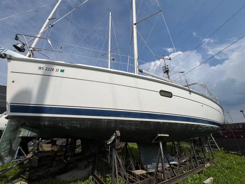 Slide: The Image of 2005 Hunter 36 sailboat on stands, side view, clear sky background. - 4