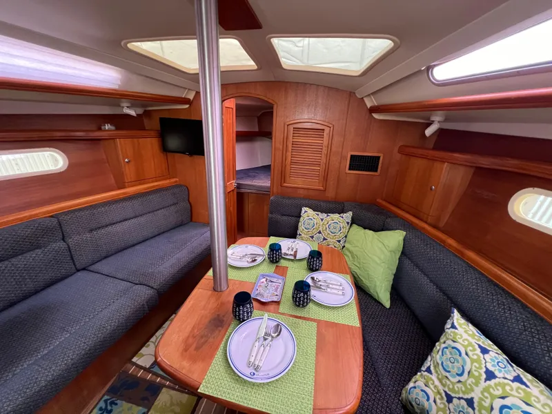 Slide: The Image of Interior of a 2005 Hunter 36 sailboat with a cozy dining area. - 40