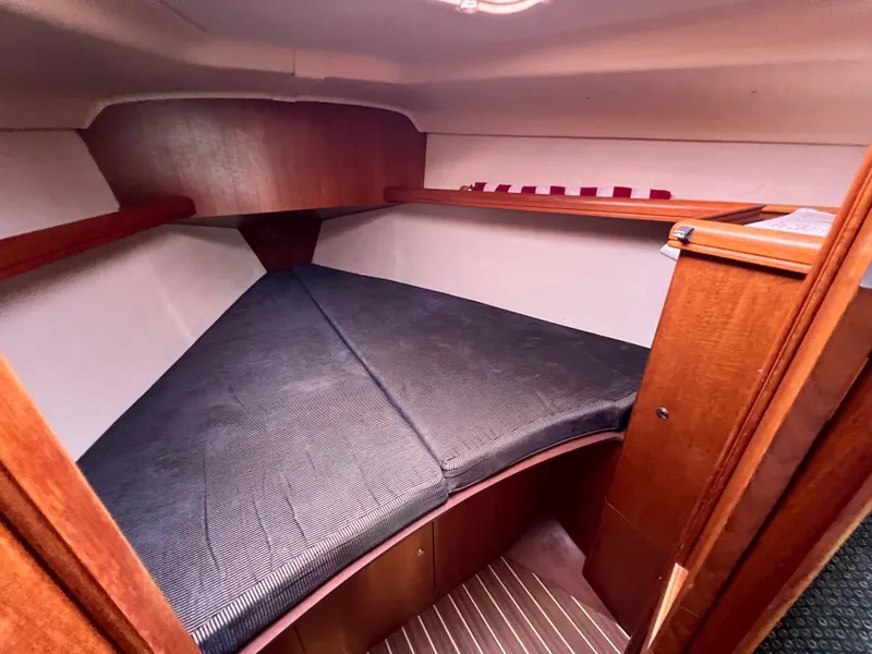 Slide: The Image of 2005 Hunter 36 sailboat interior cabin with V-berth and wooden finish. - 42
