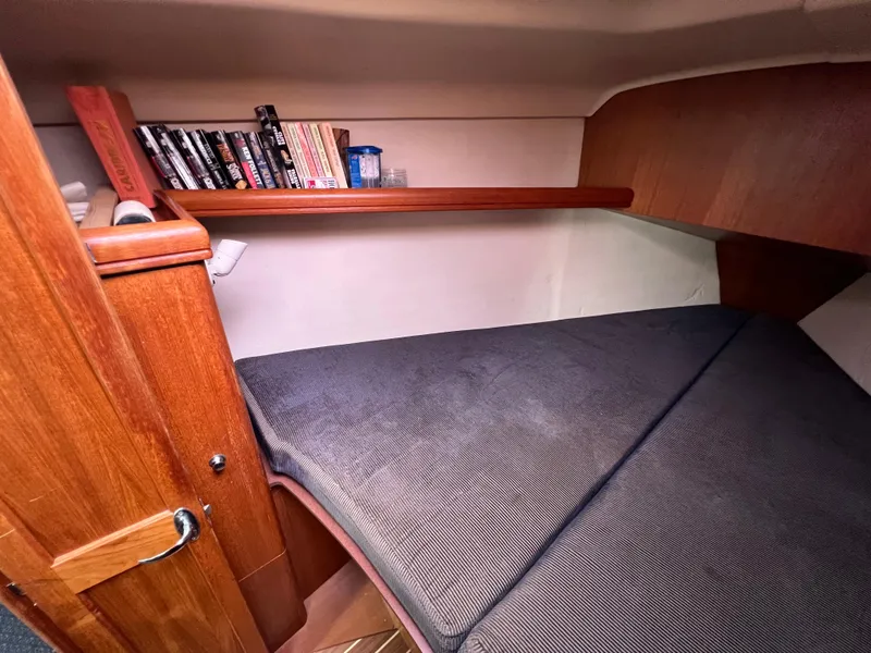 Slide: The Image of Cozy cabin bed with bookshelf in 2005 Hunter 36 sailboat. - 43
