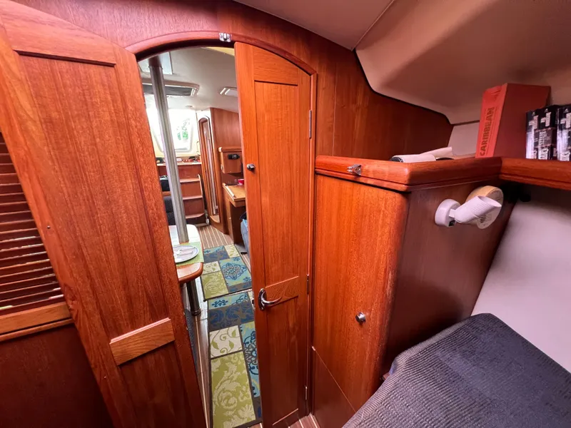 Slide: The Image of Interior of a 2005 Hunter 36 sailboat with wooden cabinetry and cozy living space. - 44
