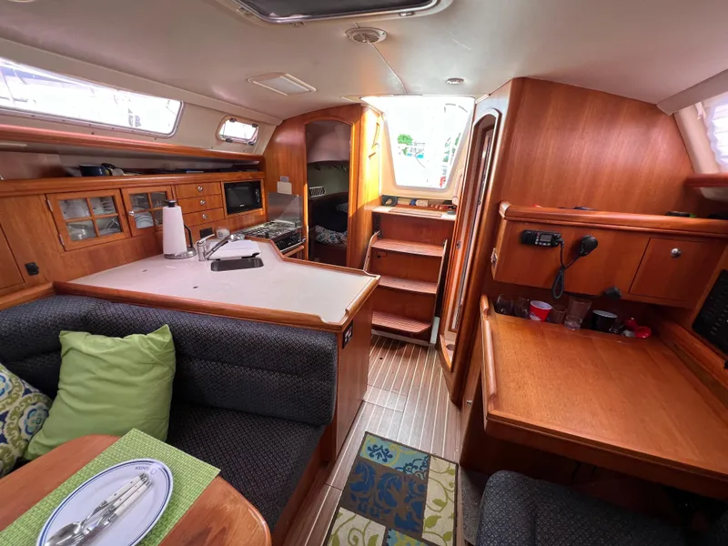 Slide: The Image of Interior of a 2005 Hunter 36 sailboat with kitchen, dining, and navigation areas. - 46