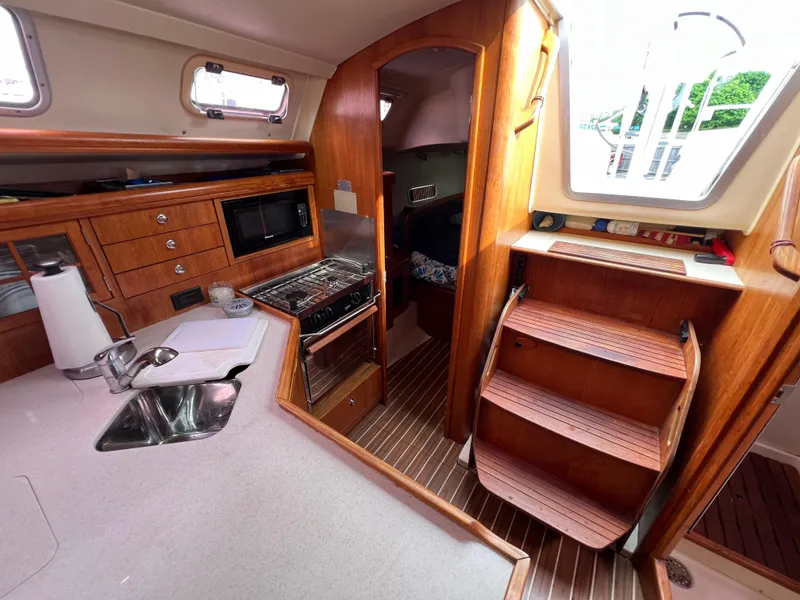 Slide: The Image of Interior of a 2005 Hunter 36 sailboat with kitchen and wooden stairs. - 47