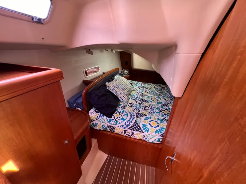 Slide: The Image of Cozy cabin interior of 2005 Hunter 36 sailboat with floral bedding and wooden finishes. - 48