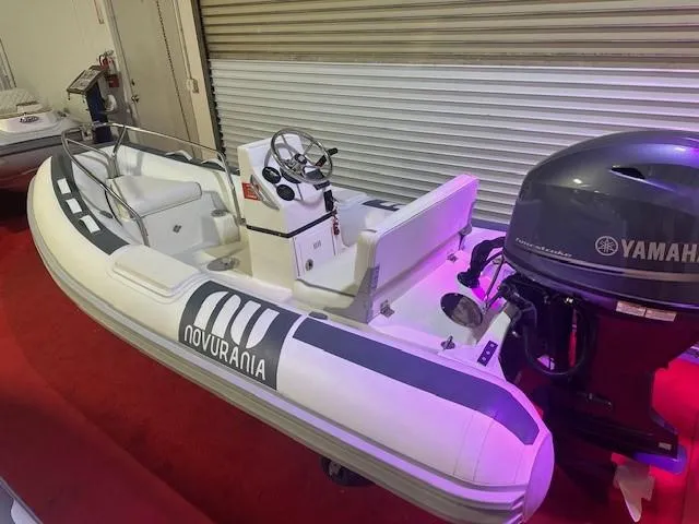 The Image of 2021 Novurania 360 DL inflatable boat with Yamaha outboard motor on display. - 0