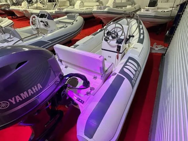 Slide: The Image of 2021 Novurania 360 DL inflatable boat with Yamaha outboard motor in showroom. - 2