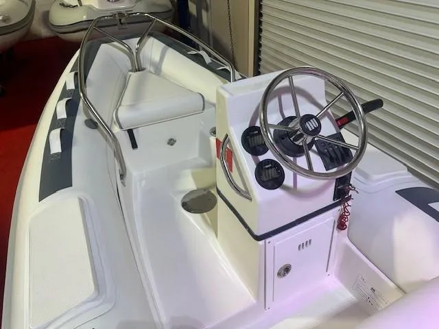 Slide: The Image of 2021 Novurania 360 DL boat interior with steering wheel and seating. - 4