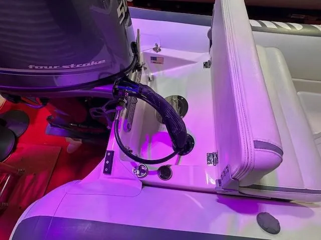 Slide: The Image of 2021 Novurania 360 DL boat interior with four-stroke engine and seating. - 8