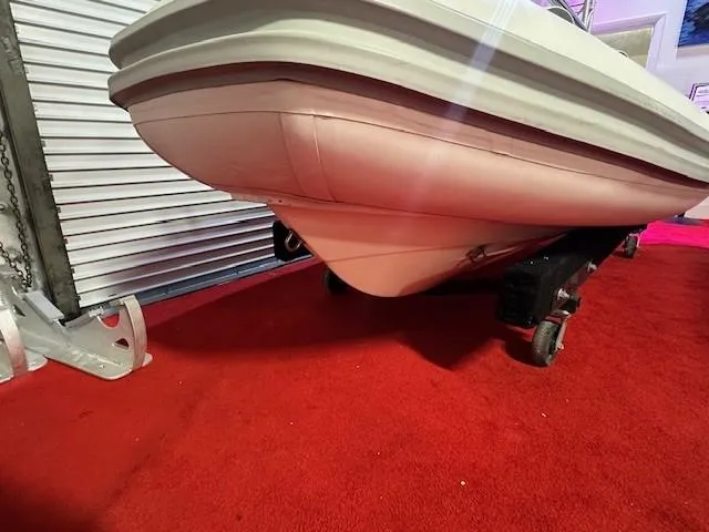Slide: The Image of 2021 Novurania 360 DL boat on red carpet in storage. - 9