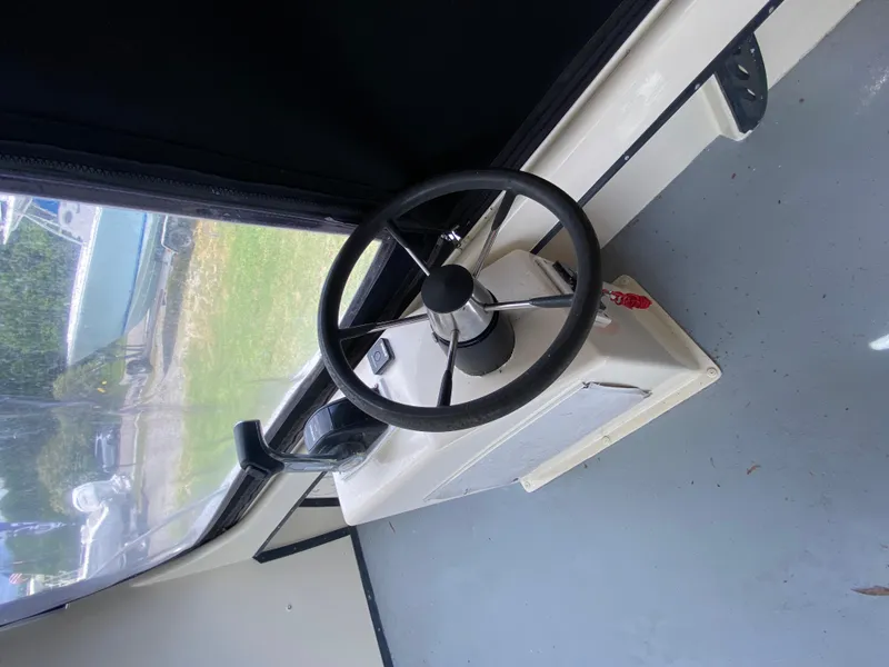 Slide: The Image of Steering wheel of 2005 C-Hawk Pilothouse 25 boat interior. - 13