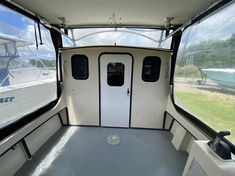 Slide: The Image of 2005 C-Hawk Pilothouse 25 interior with enclosed cabin and clear windows. - 14
