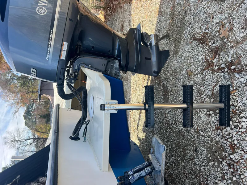 Slide: The Image of 2005 C-Hawk Pilothouse 25 with Yamaha outboard motor on gravel surface. - 20