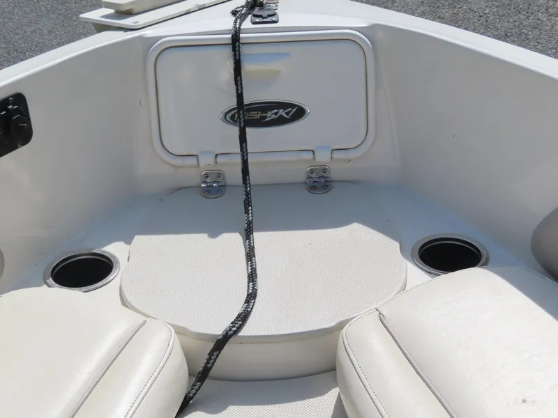Slide: The Image of 2013 Stingray 195LX boat interior with storage compartment and cup holders. - 11