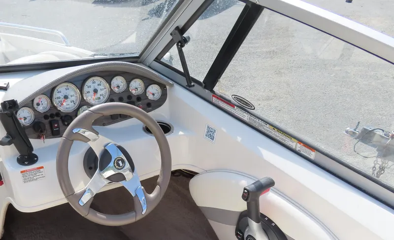 Slide: The Image of 2013 Stingray 195LX boat dashboard with steering wheel and control panel. - 15