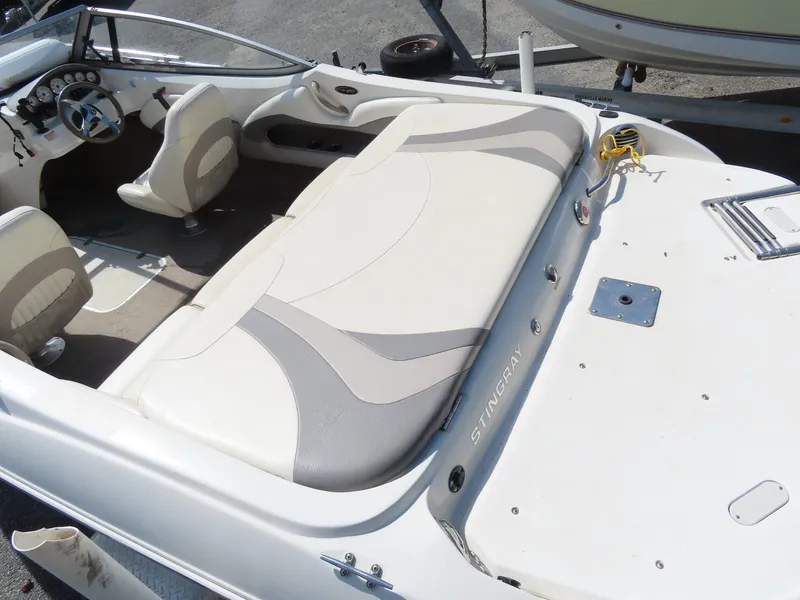 Slide: The Image of 2013 Stingray 195LX boat interior with beige and gray seating. - 17