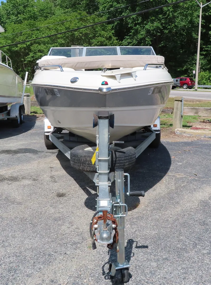 Slide: The Image of 2013 Stingray 195LX boat on a trailer in a parking lot. - 3